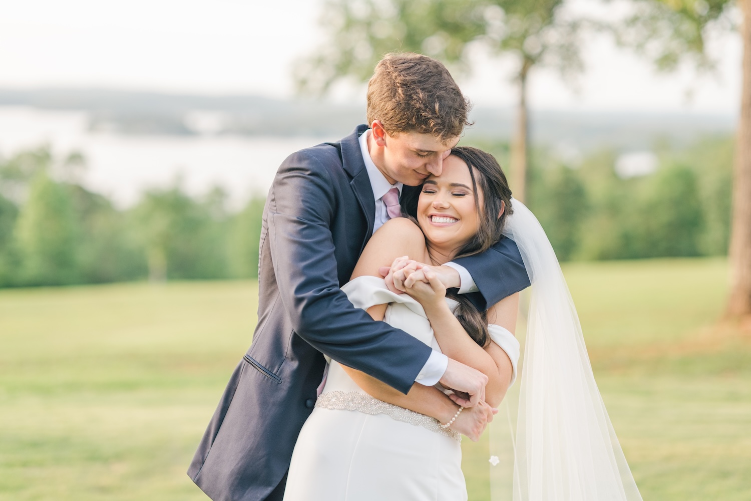 bride and groom posing by snuggling in to each other for sunset portraits on their wedding day