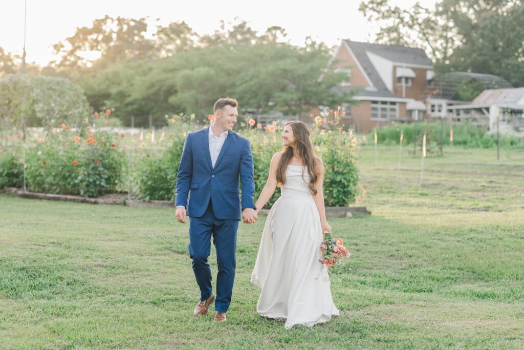 bride and groom portrait of couple walking on a flower farm